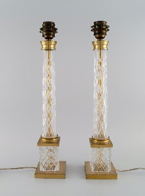 #ad A pair of tall and sleek table lamps in clear crystal glass and brass. $1000.00
